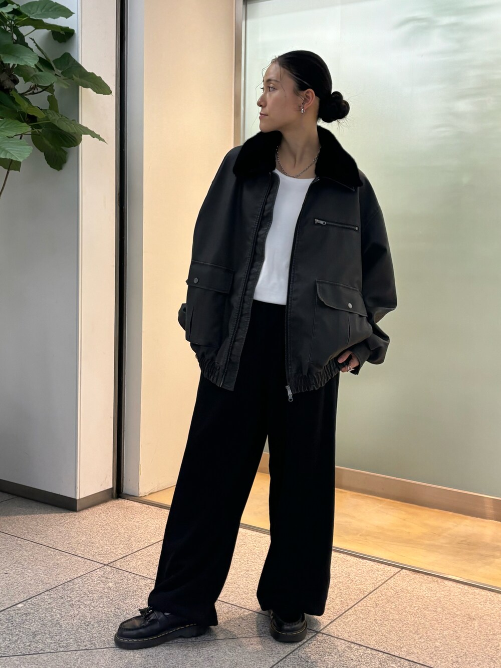 ブラック系のスラックスを着用したレディースの秋コーディネートの3枚目の写真