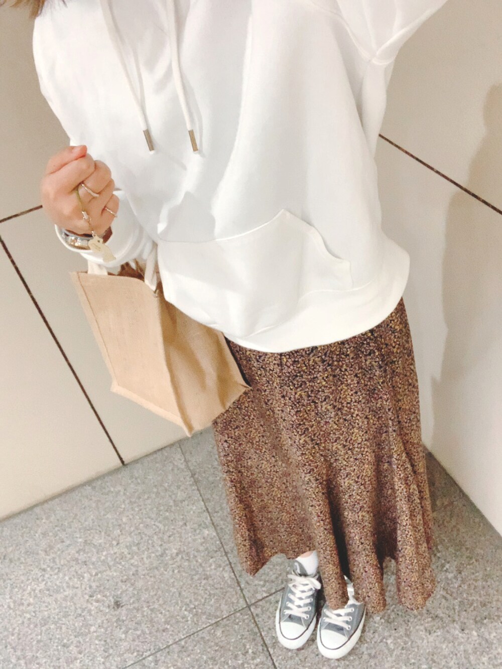 グレー系のスニーカー、その他のスカート、ホワイト系のパーカーを着用したレディースの春コーディネートの2枚目の写真