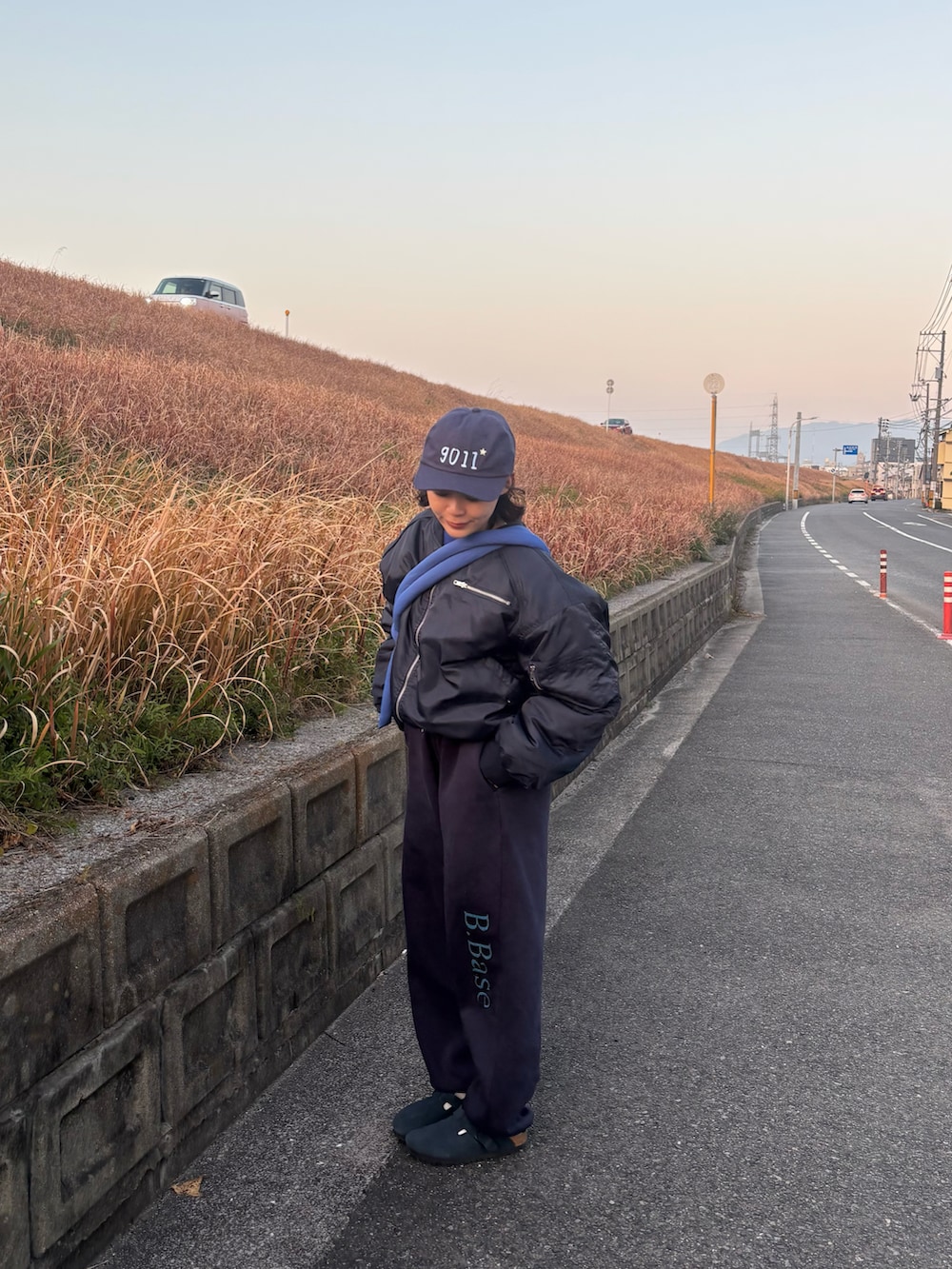 ブルー系のMA-1、ブルー系のハンドバッグ、ブルー系のスウェットパンツを着用したレディースの冬コーディネートの2枚目の写真