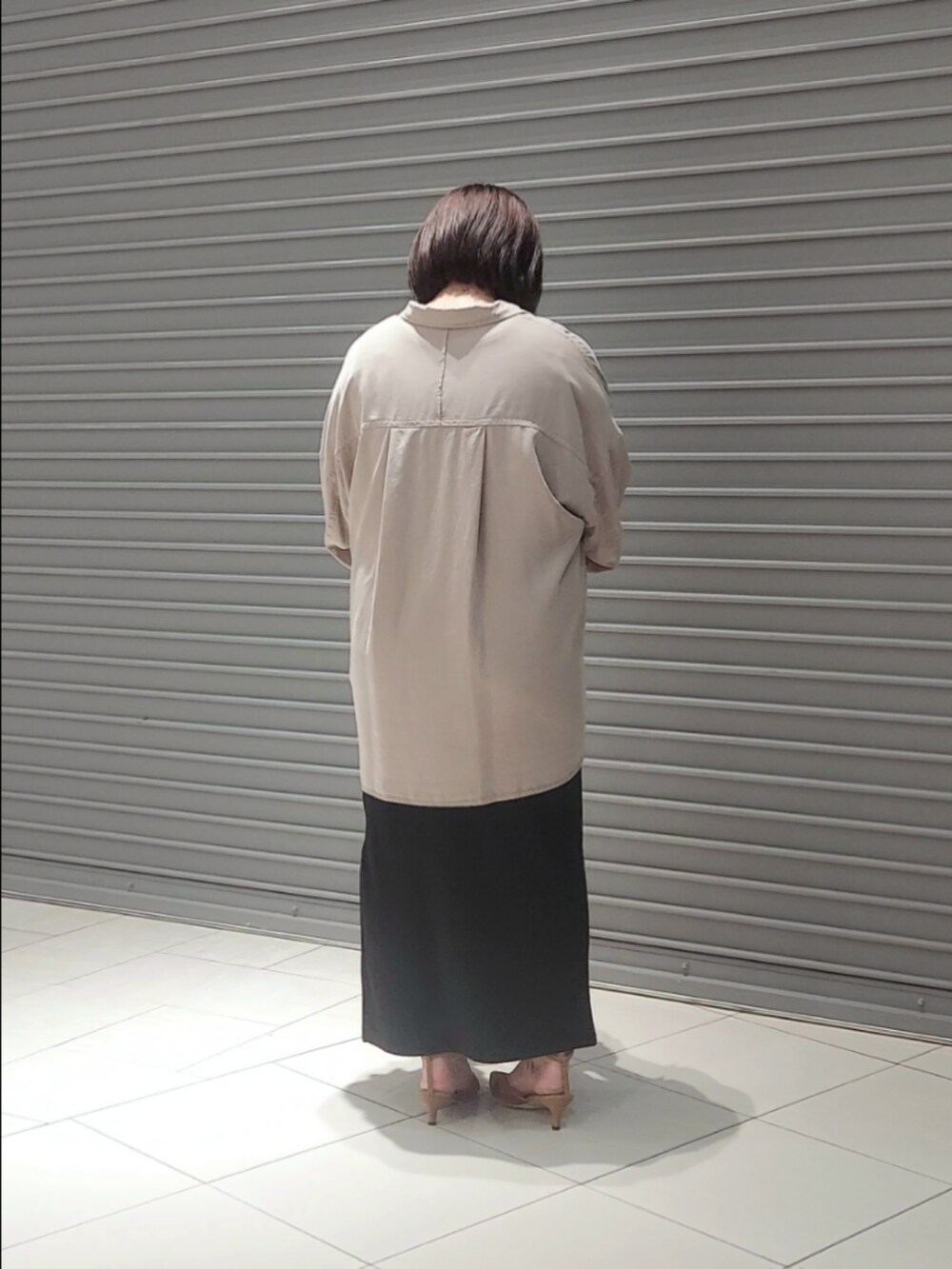 グレー系のシャツ/ブラウス、ブラック系のワンピース、ブラウン系のパンプスを着用したレディースの夏コーディネートの2枚目の写真