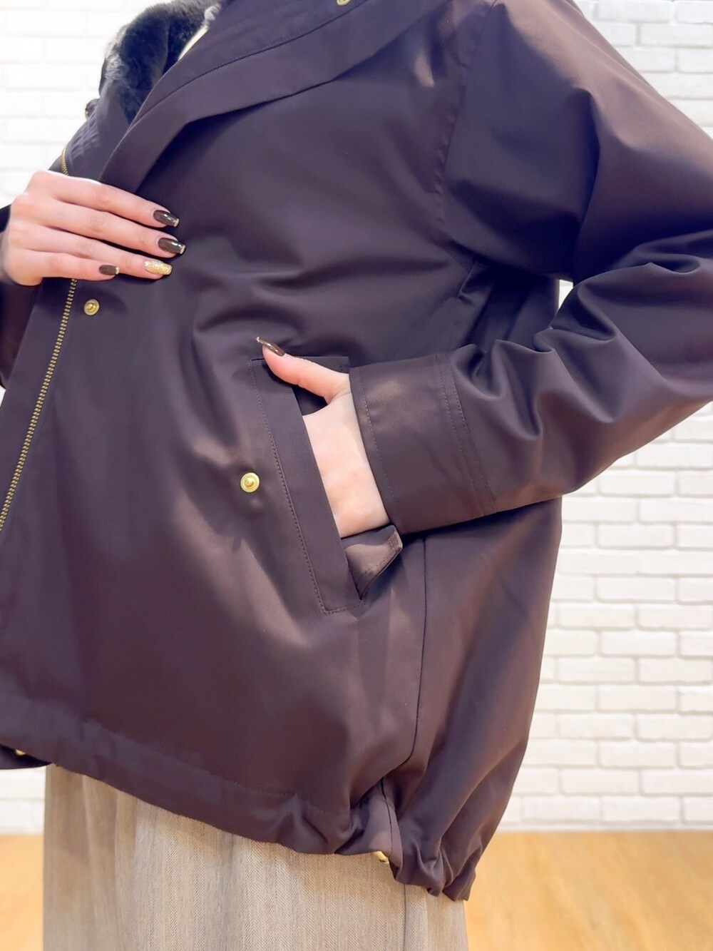 ブラウン系のブルゾン、ホワイト系のTシャツ/カットソー、ベージュ系のその他パンツを着用したレディースの秋コーディネートの6枚目の写真