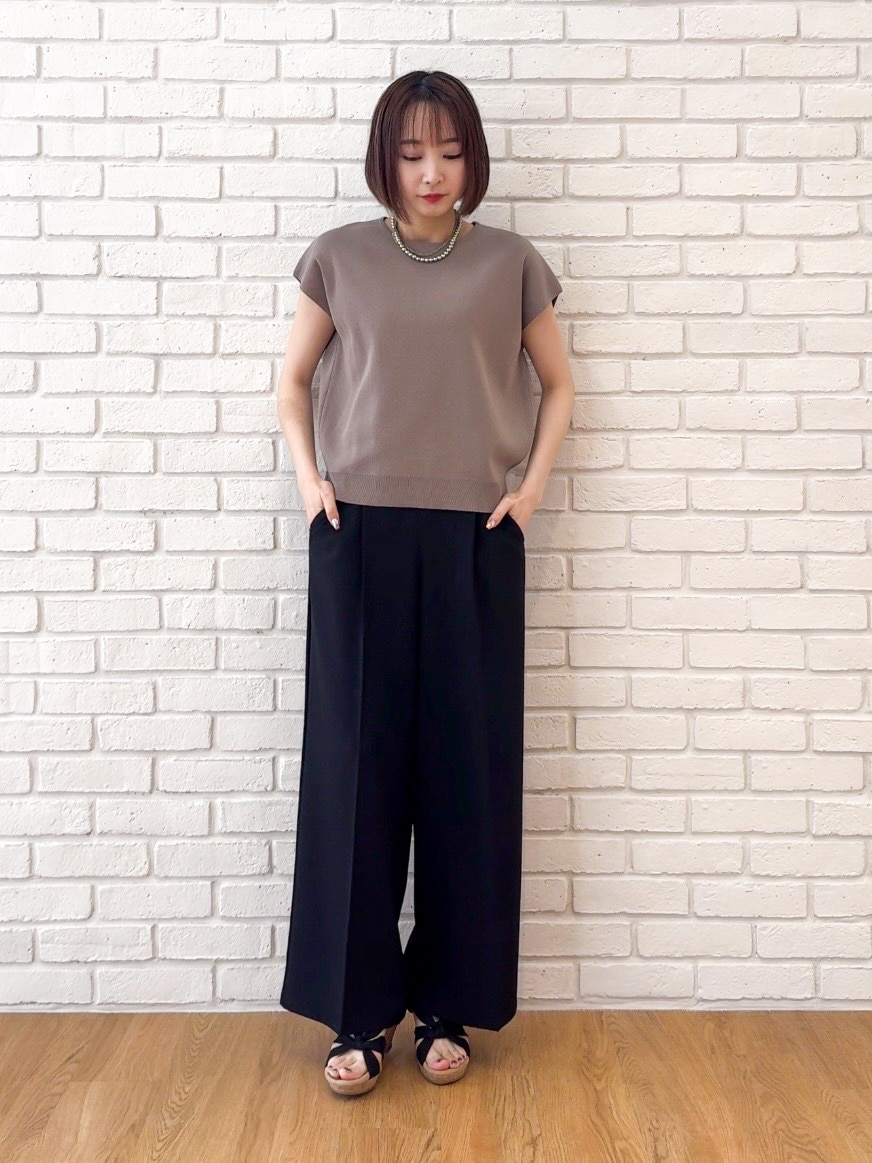 ベージュ系のニット/セーター、ブラック系のその他パンツ、ブラック系のサンダルを着用したレディースの夏コーディネートの5枚目の写真