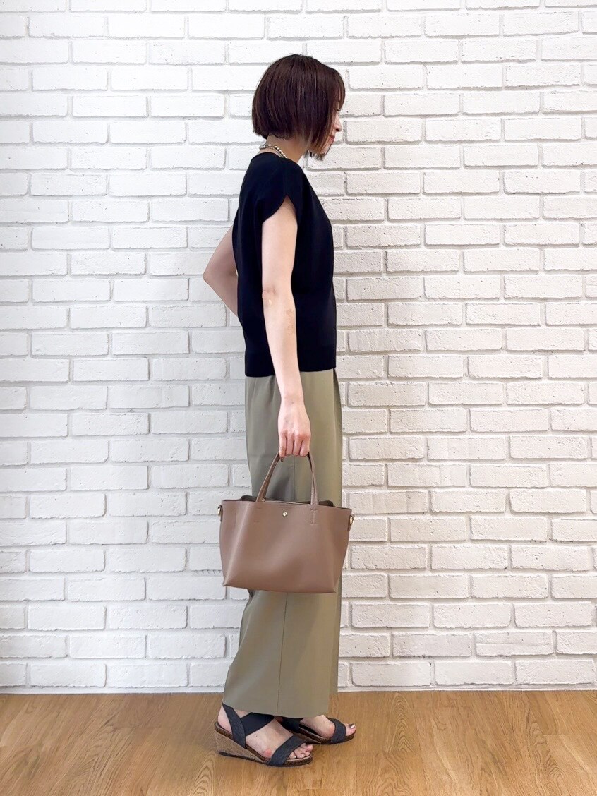 ブラック系のニット/セーター、グリーン系のその他パンツ、ブラック系のサンダルを着用したレディースの夏コーディネートの8枚目の写真