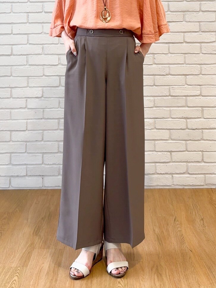オレンジ系のシャツ/ブラウス、ブラウン系のその他パンツ、ホワイト系のサンダルを着用したレディースの夏コーディネートの8枚目の写真