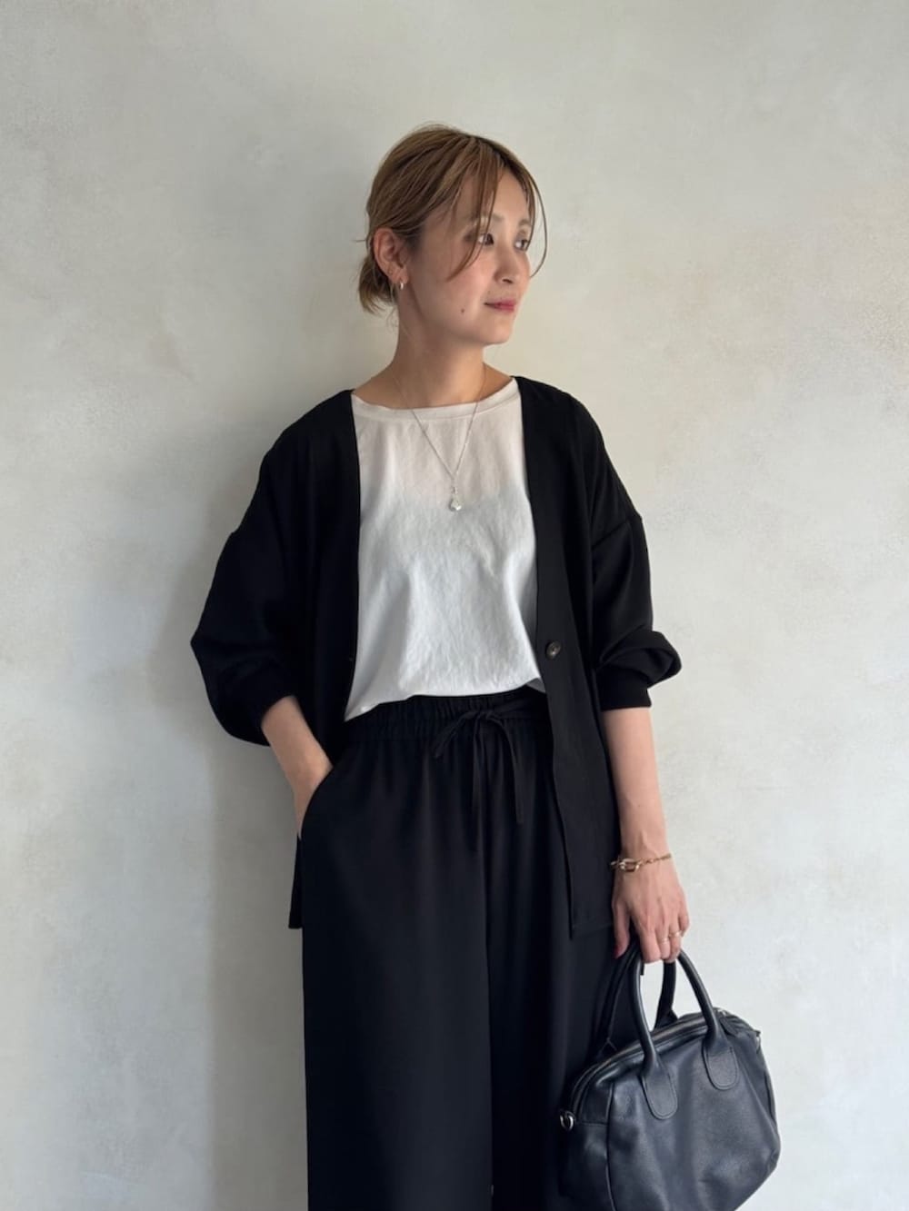 ブラック系のその他アウター、ホワイト系のシャツ/ブラウス、ブラック系のその他パンツを着用したレディースの春コーディネートの6枚目の写真