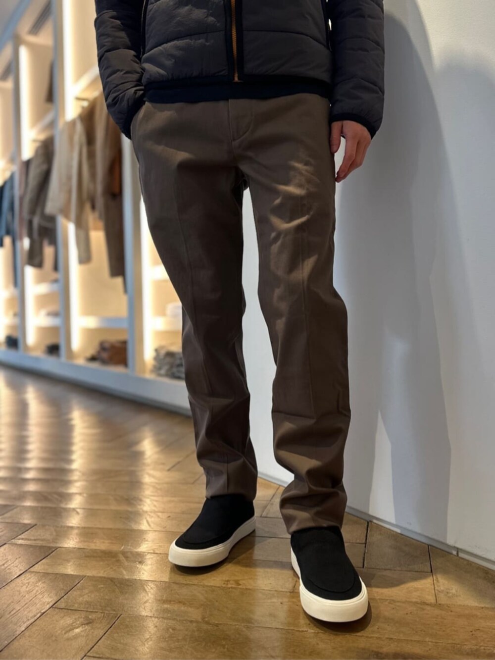 ブラック系のスリッポン、ベージュ系のスラックス、ブラック系のブルゾンを着用したメンズの冬コーディネートの3枚目の写真