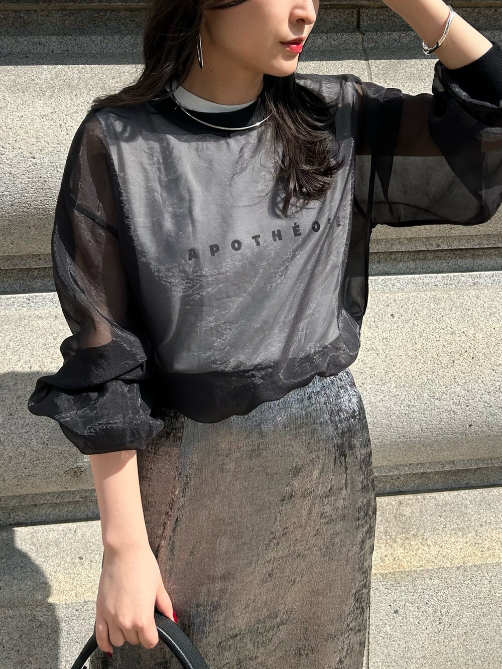 シルバー系のスカート、ブラック系のシャツ/ブラウスを着用したレディースの夏コーディネートの4枚目の写真