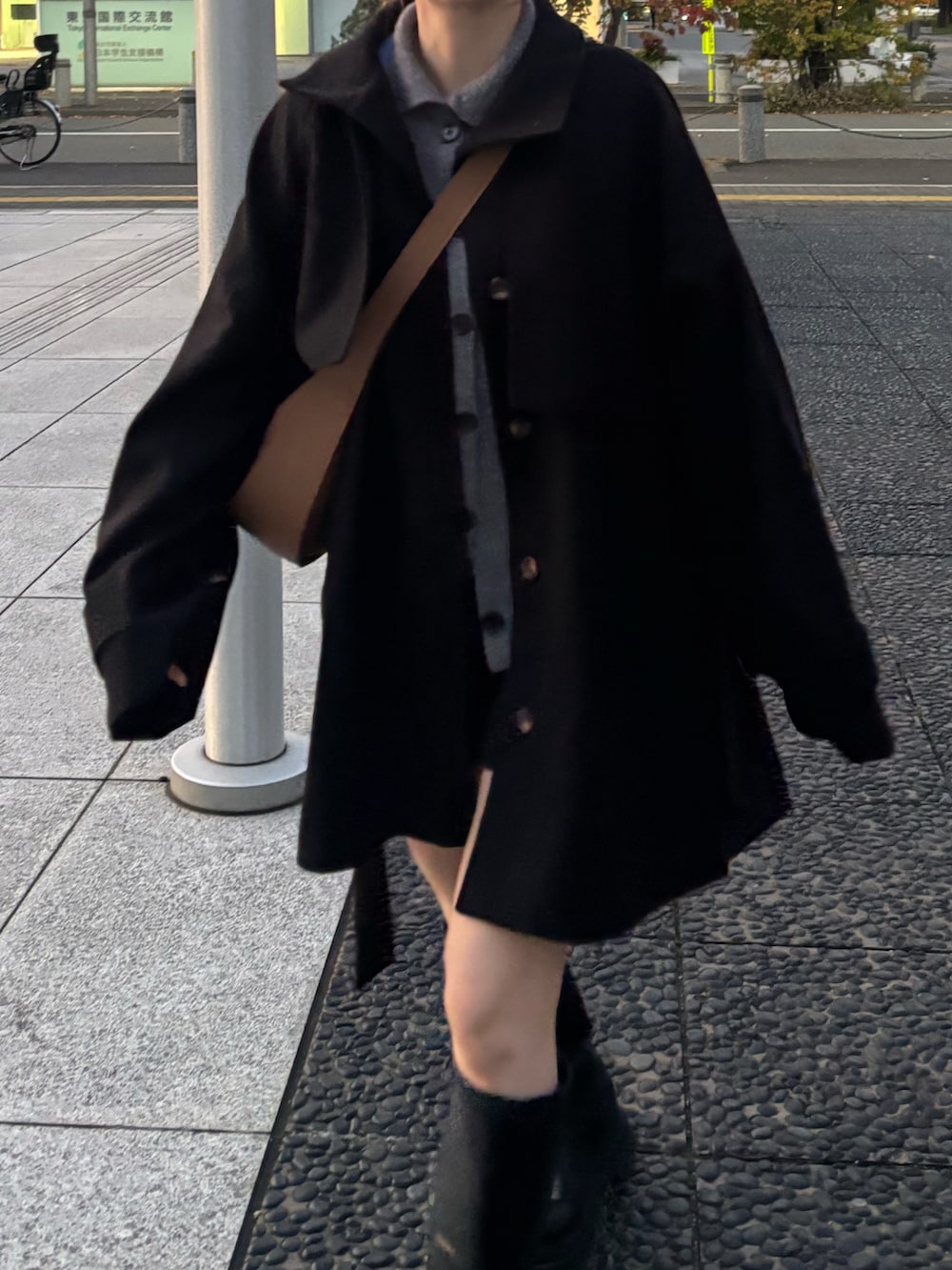 ブラック系のブーツ、ブラック系のトレンチコートを着用したレディースの秋コーディネートの2枚目の写真