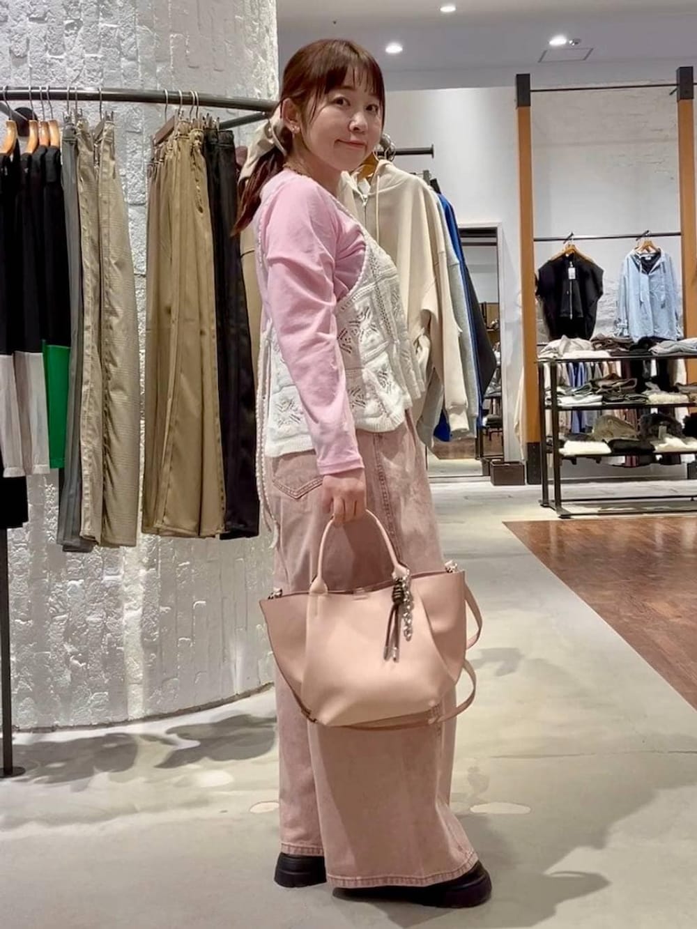 ピンク系のTシャツ/カットソー、ピンク系のデニムパンツ、ブラック系のその他シューズを着用したレディースの冬コーディネートの4枚目の写真