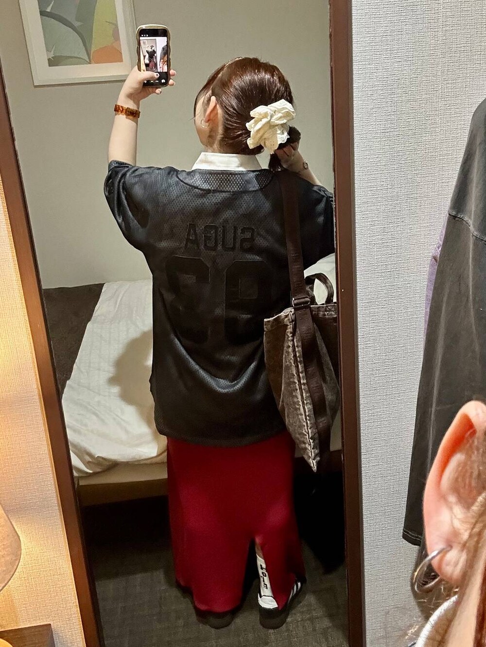 レッド系のスカート、ブラック系のスニーカー、ブラウン系のスニーカーを着用したレディースの春コーディネートの4枚目の写真