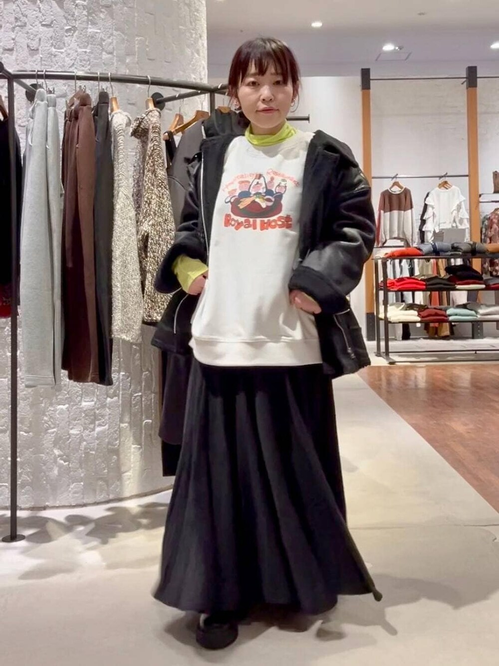 ブラック系のショルダーバッグ、ブラック系のその他アウター、ブラック系のブーツを着用したレディースの冬コーディネートの2枚目の写真