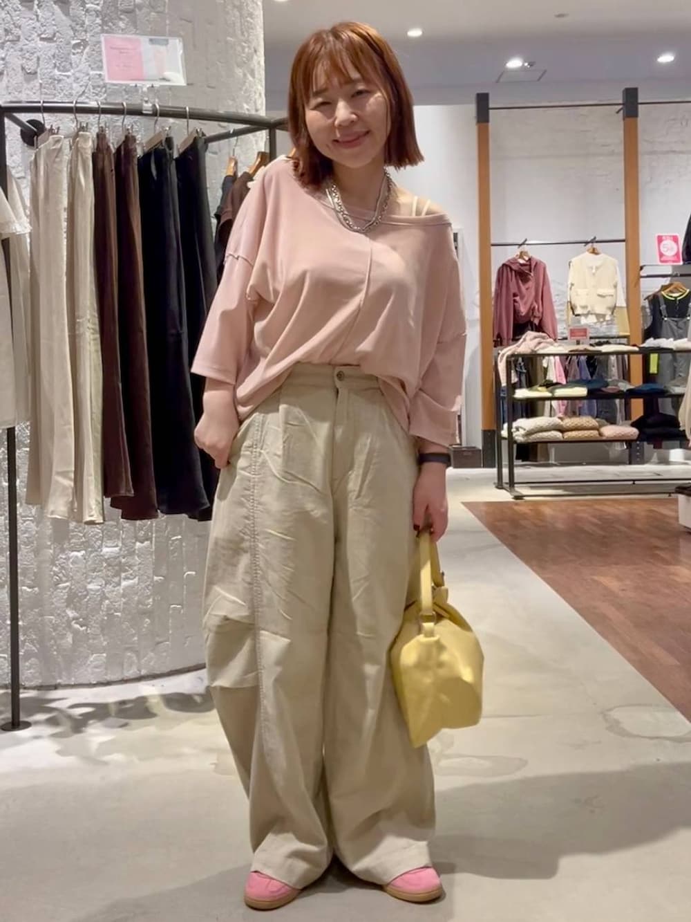 ベージュ系のその他パンツ、イエロー系のショルダーバッグ、ピンク系のTシャツ/カットソーを着用したレディースの秋コーディネートの6枚目の写真