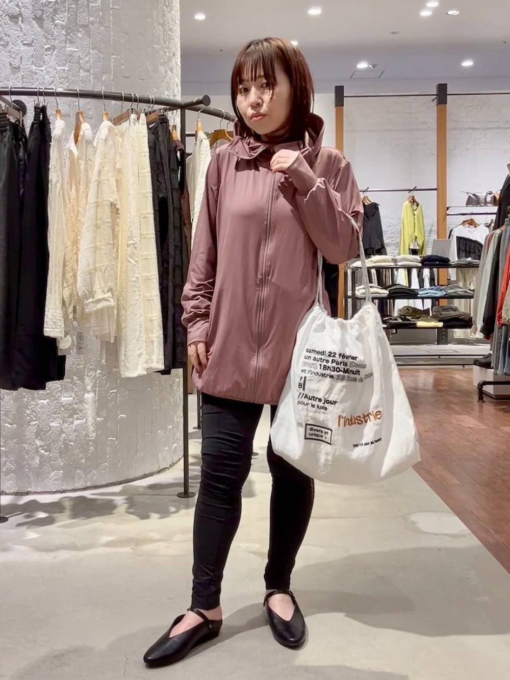 ホワイト系のトートバッグ、レッド系のタンクトップ、ブラック系のパンプスを着用したレディースの春コーディネートの2枚目の写真