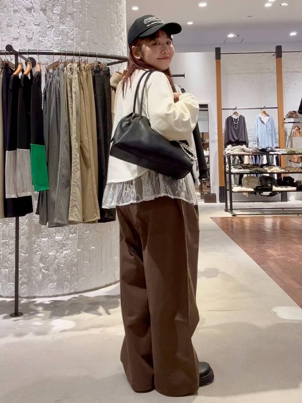 ホワイト系のTシャツ/カットソー、グリーン系のその他パンツ、ブラック系のボストンバッグを着用したレディースの冬コーディネートの3枚目の写真