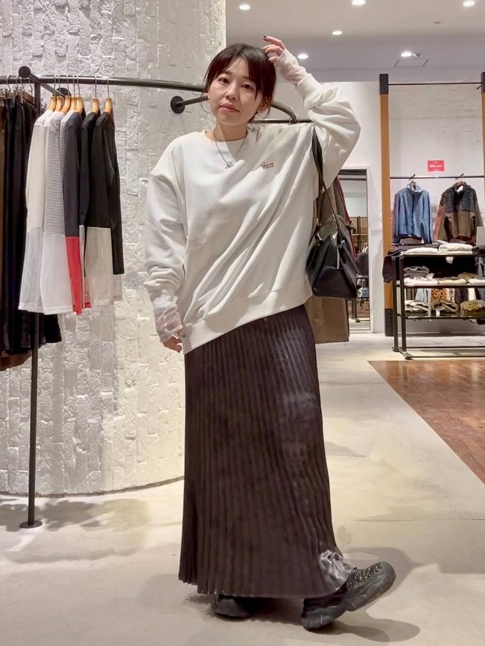 ホワイト系のTシャツ/カットソー、グレー系のその他アウター、グレー系のスカートを着用したレディースの冬コーディネートの9枚目の写真