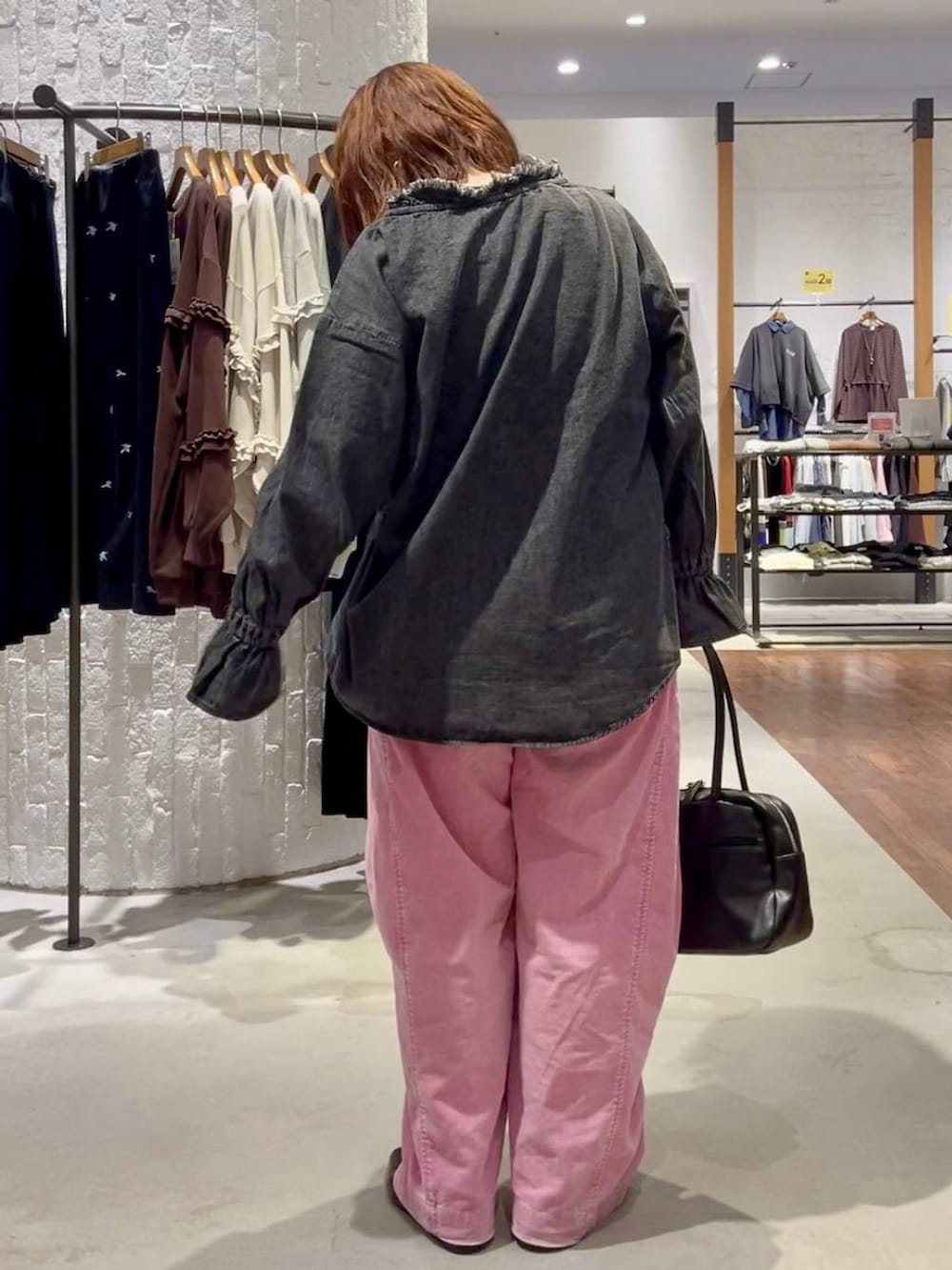 ピンク系のその他パンツ、ブラック系のボストンバッグ、ブラック系のTシャツ/カットソーを着用したレディースの秋コーディネートの4枚目の写真