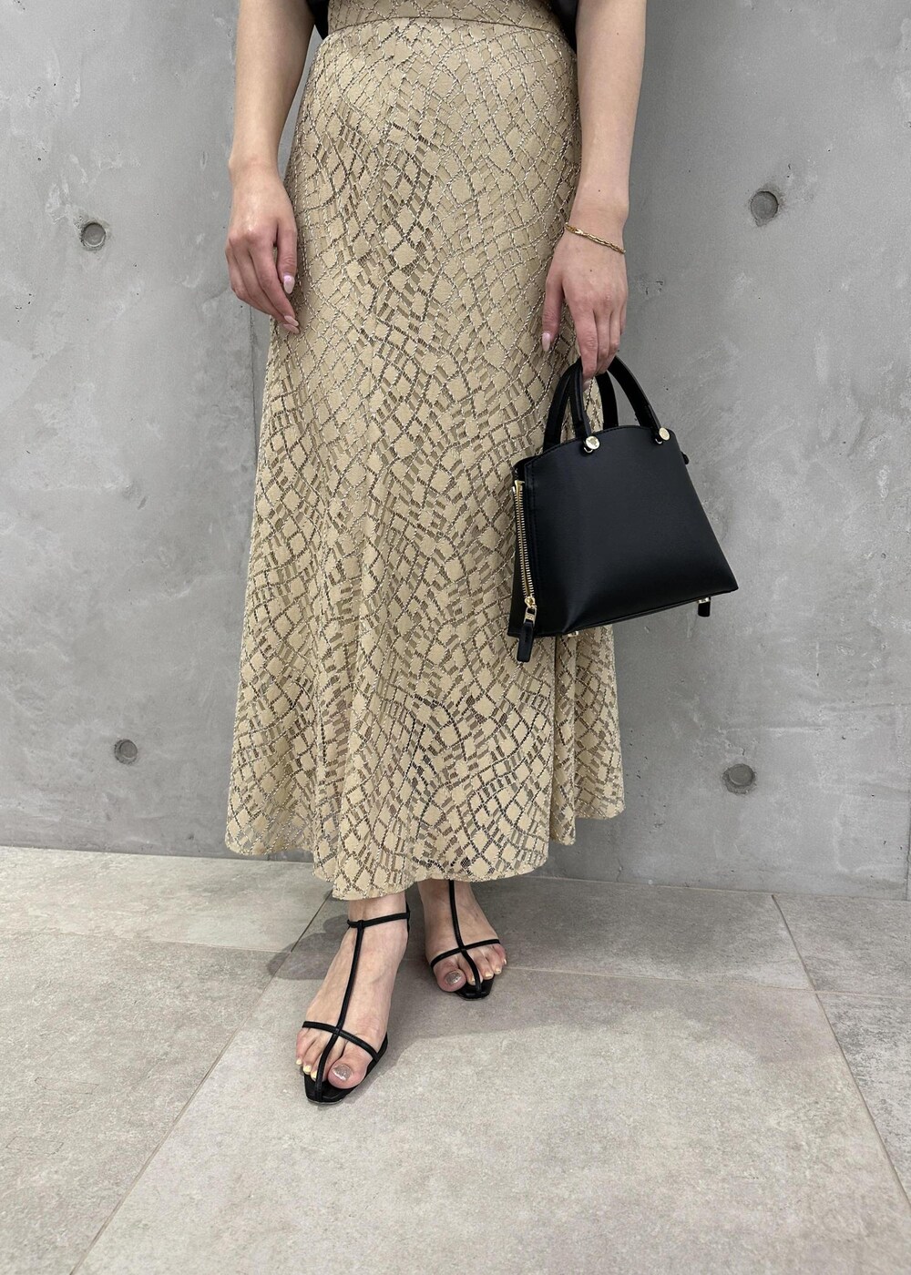 ブラック系のハンドバッグ、ブラック系のサンダル、ブラウン系のシャツ/ブラウスを着用したレディースの夏コーディネートの6枚目の写真