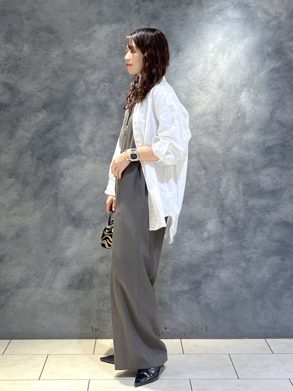 ブラック系のパンプス、ホワイト系のシャツ/ブラウス、グレー系のつなぎ/オールインワンを着用したレディースの春コーディネートの4枚目の写真