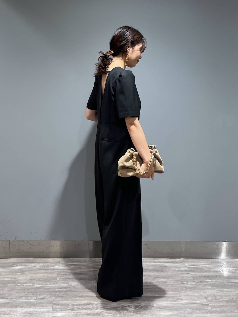 ブラック系のパンプス、ベージュ系のショルダーバッグ、ブラック系のつなぎ/オールインワンを着用したレディースの秋コーディネートの2枚目の写真