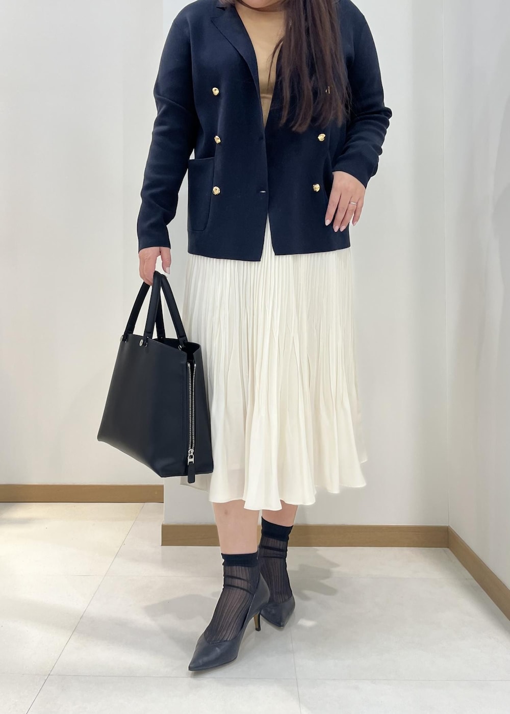 ホワイト系のスカート、ブルー系のテーラードジャケット、オレンジ系のTシャツ/カットソーを着用したレディースの春コーディネートの6枚目の写真