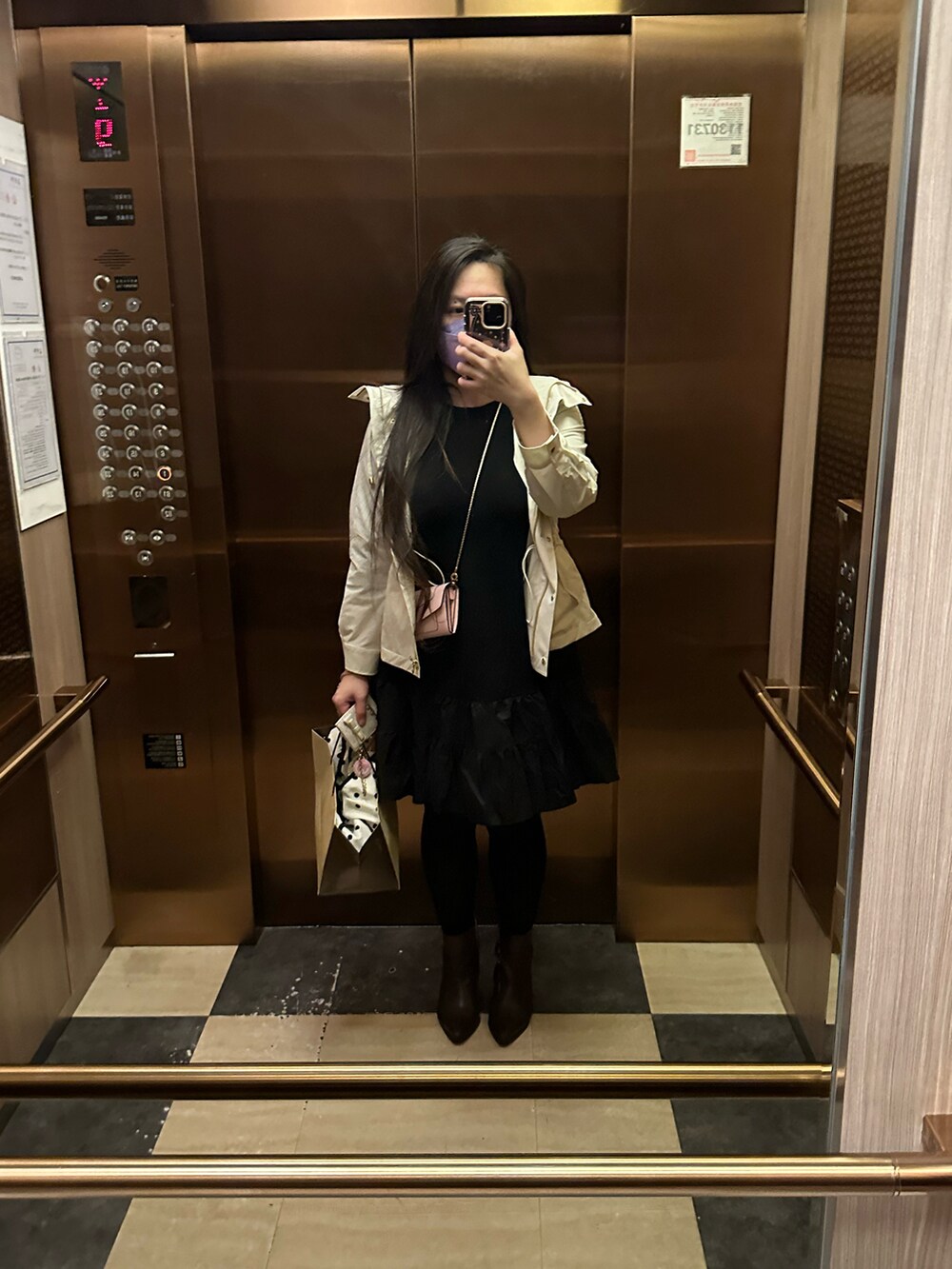 ブラック系のワンピース、ホワイト系のその他アウター、ブラウン系のブーツを着用したレディースの秋コーディネートの3枚目の写真