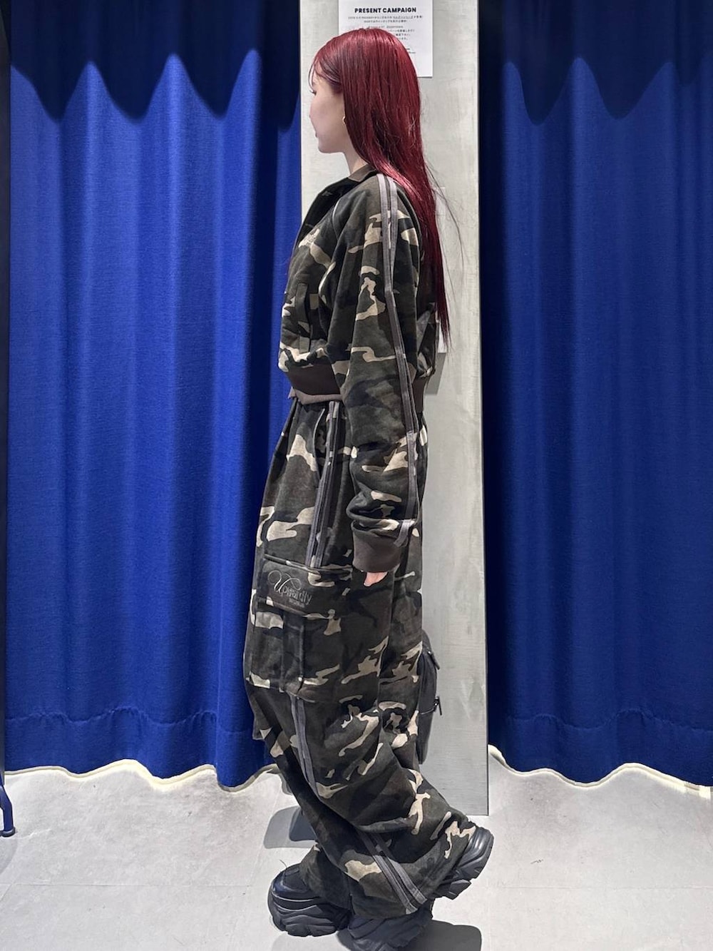 ブラック系のスニーカー、ブラック系のボストンバッグ、ホワイト系のキャミソールを着用したレディースの冬コーディネートの3枚目の写真