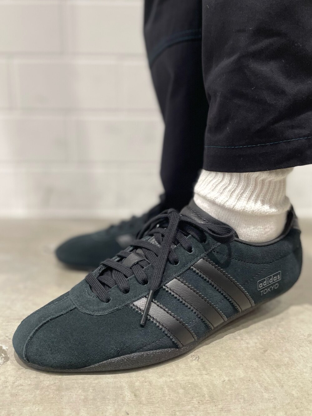 イエロー系のブルゾン、ブラック系のその他パンツ、ブラック系のスニーカーを着用したレディースの冬コーディネートの6枚目の写真