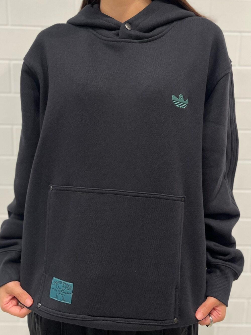 ブラック系のスウェットパンツ、ブルー系のスニーカー、ブラック系のトップスを着用したレディースの秋コーディネートの4枚目の写真