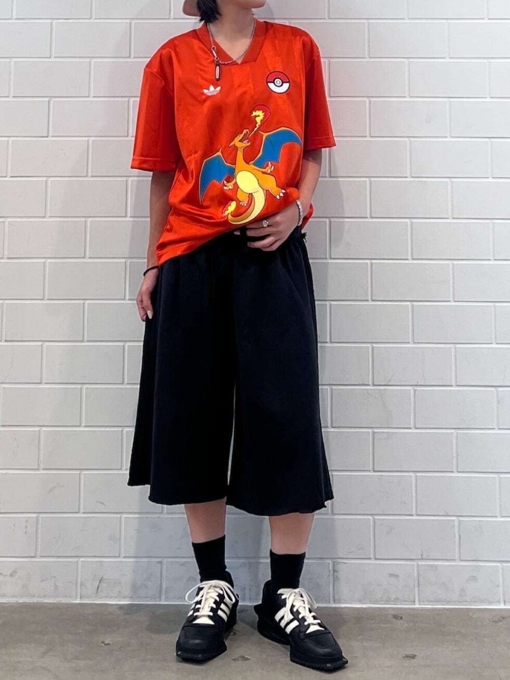ブラック系のシューズ、オレンジ系のTシャツ/カットソー、ブラック系のその他パンツを着用したレディースの秋コーディネートの2枚目の写真