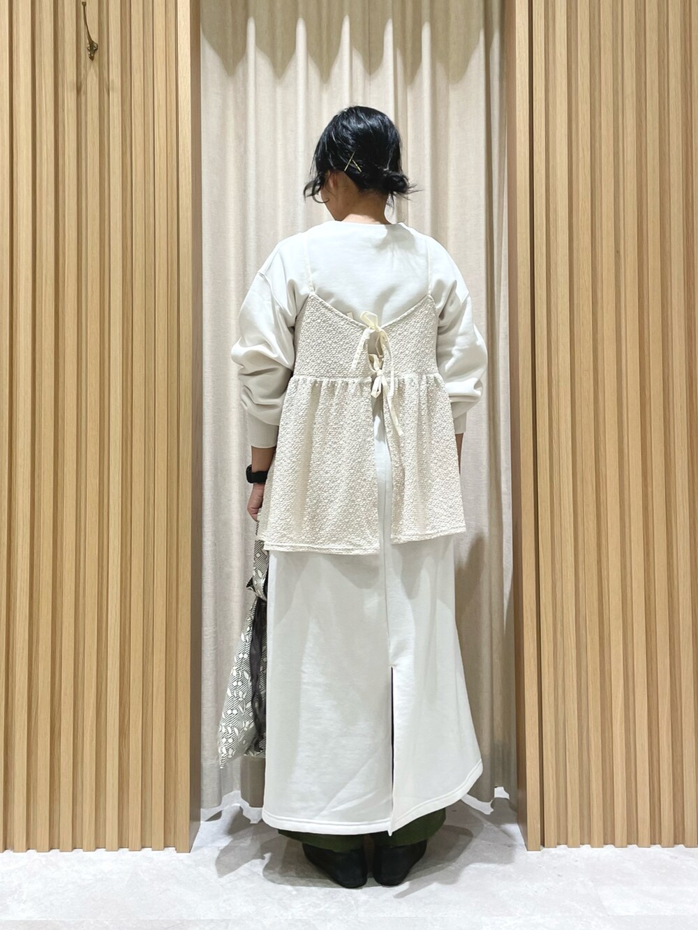 ホワイト系のTシャツ/カットソー、ホワイト系のワンピース/ドレス、ベージュ系のハンドバッグを着用したレディースの冬コーディネートの2枚目の写真