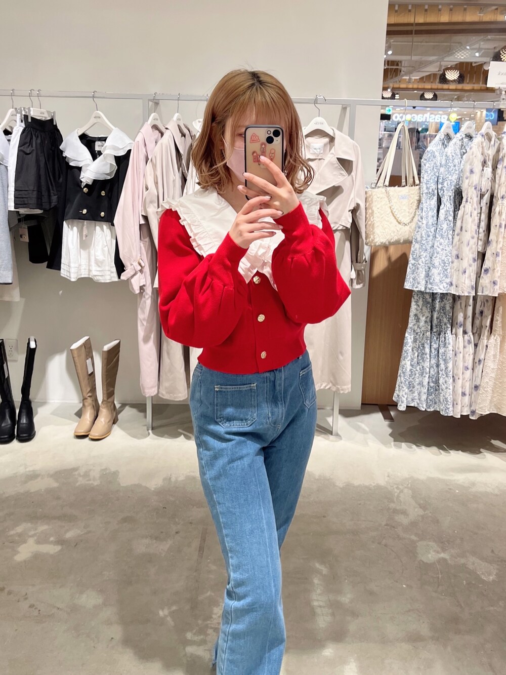 ホワイト系のトートバッグ、ホワイト系のシャツ/ブラウス、レッド系のカーディガン/ボレロを着用したレディースの春コーディネートの3枚目の写真