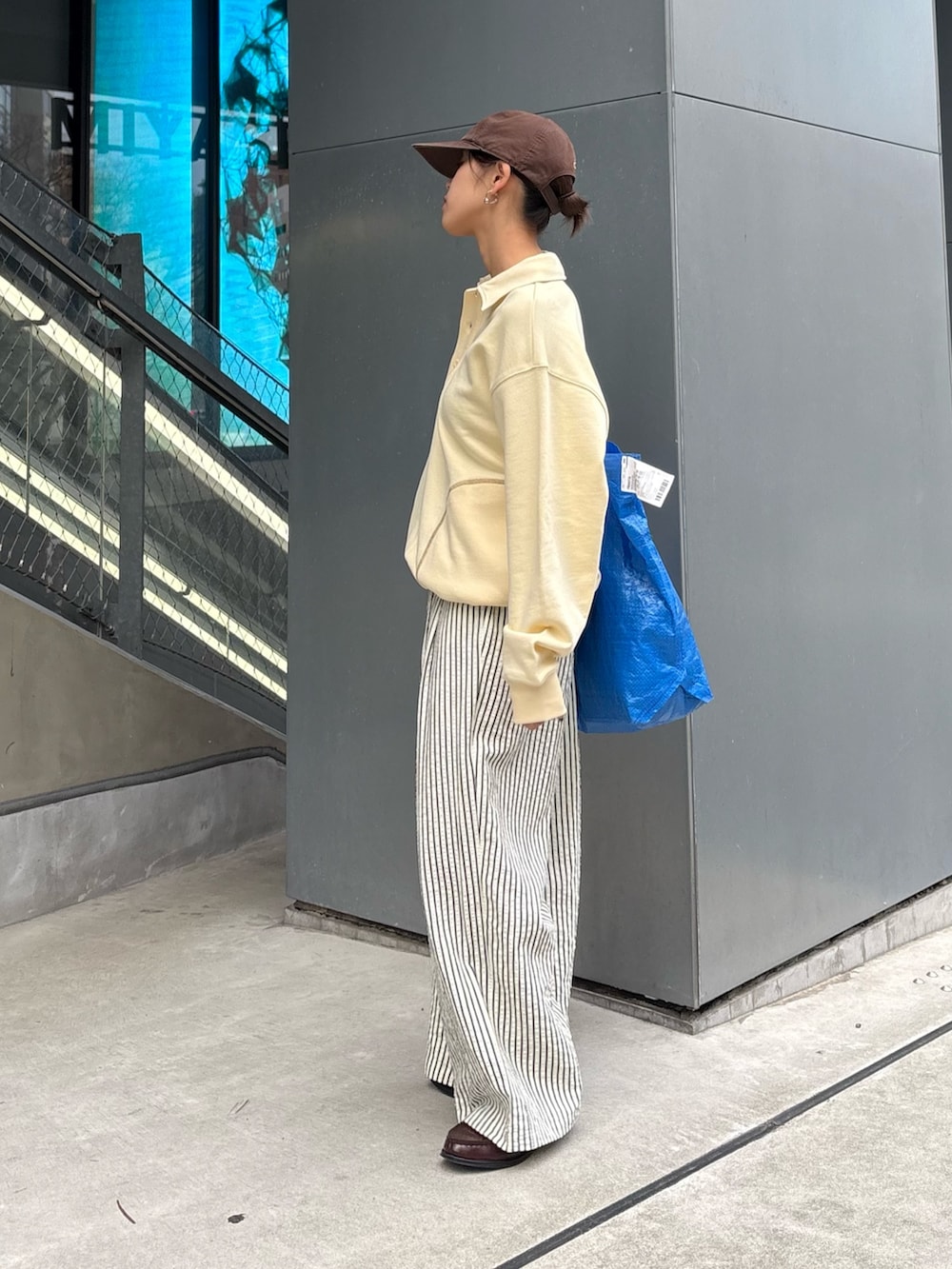 イエロー系のスウェット、ホワイト系のその他パンツを着用したレディースの春コーディネートの2枚目の写真