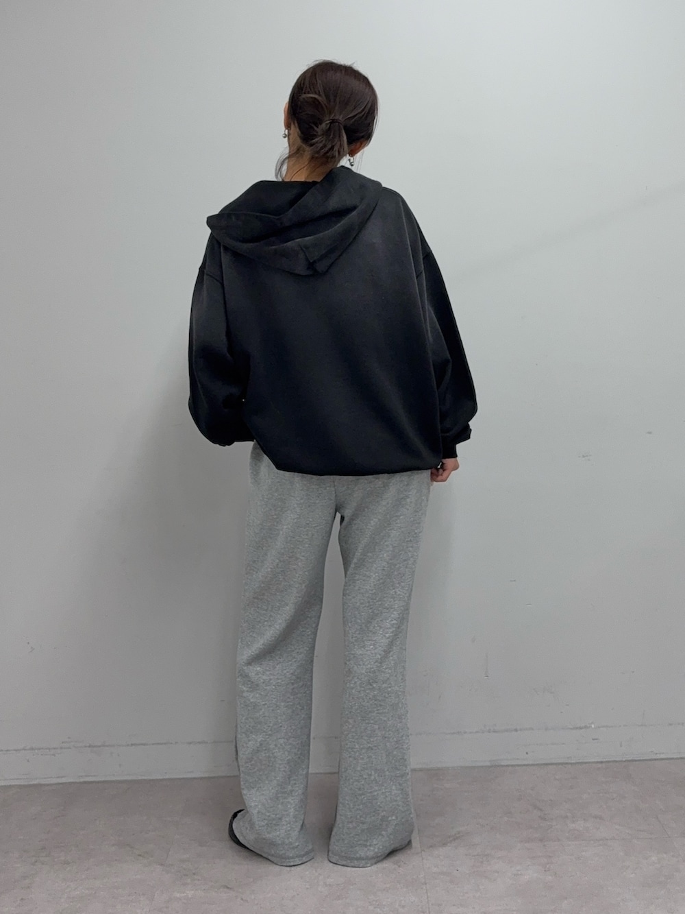 ブラック系のパーカー、グレー系のその他パンツ、ブラック系のローファーを着用したレディースの冬コーディネートの2枚目の写真