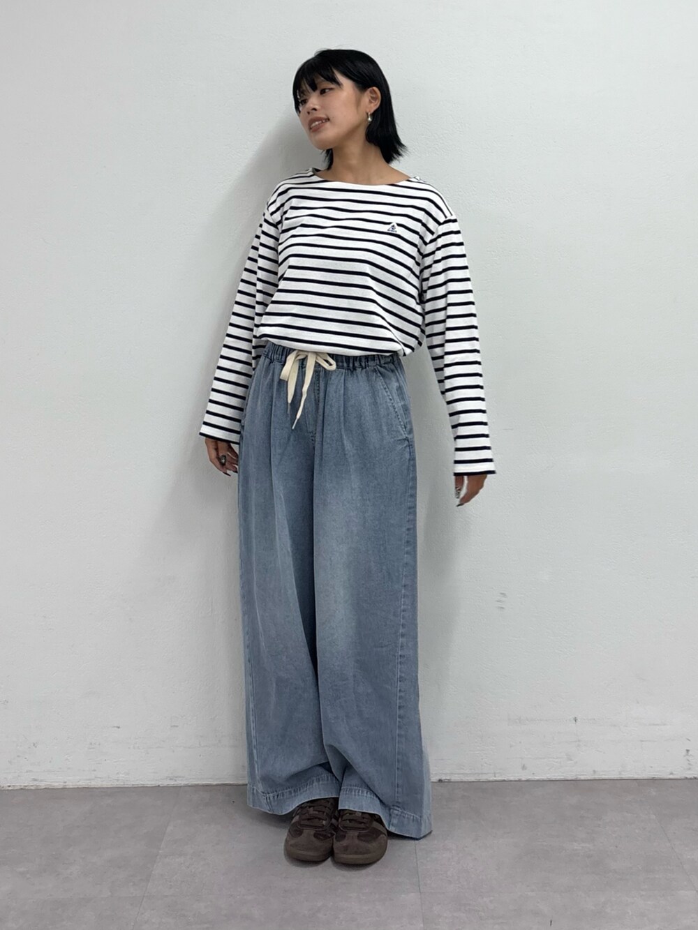 ホワイト系のTシャツ/カットソー、ブルー系のデニムパンツを着用したレディースの夏コーディネートの2枚目の写真