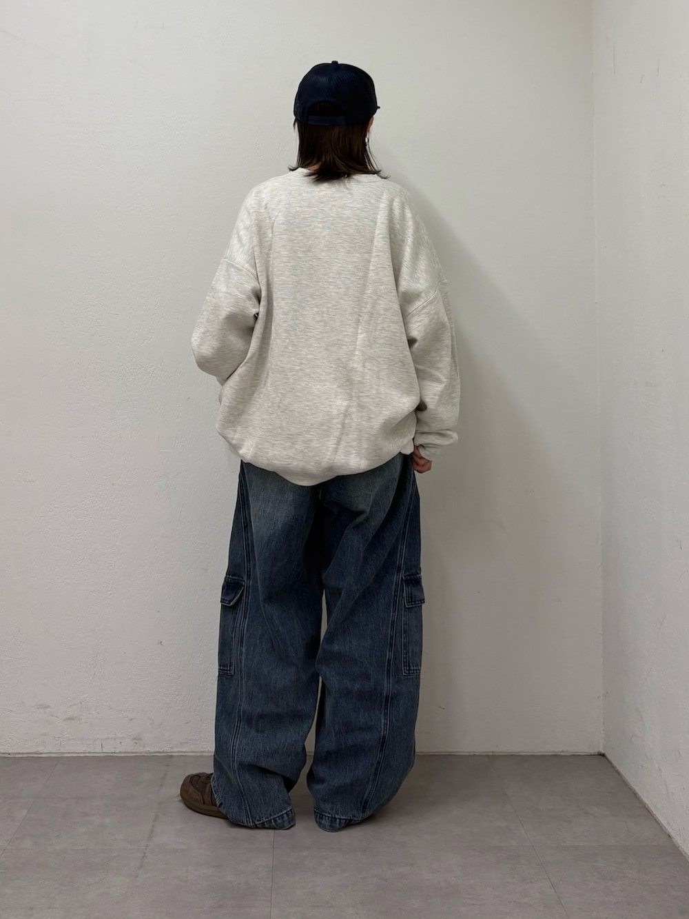 グレー系のスウェット、ホワイト系のTシャツ/カットソー、ブルー系のカーゴパンツを着用したレディースの冬コーディネートの3枚目の写真