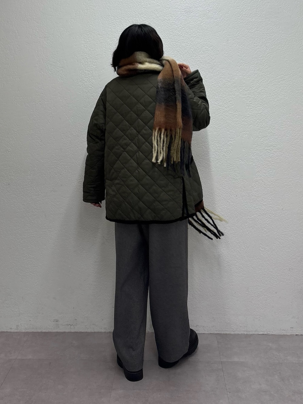 グリーン系のブルゾン、グレー系のスウェット、グレー系のスラックスを着用したレディースの秋コーディネートの3枚目の写真