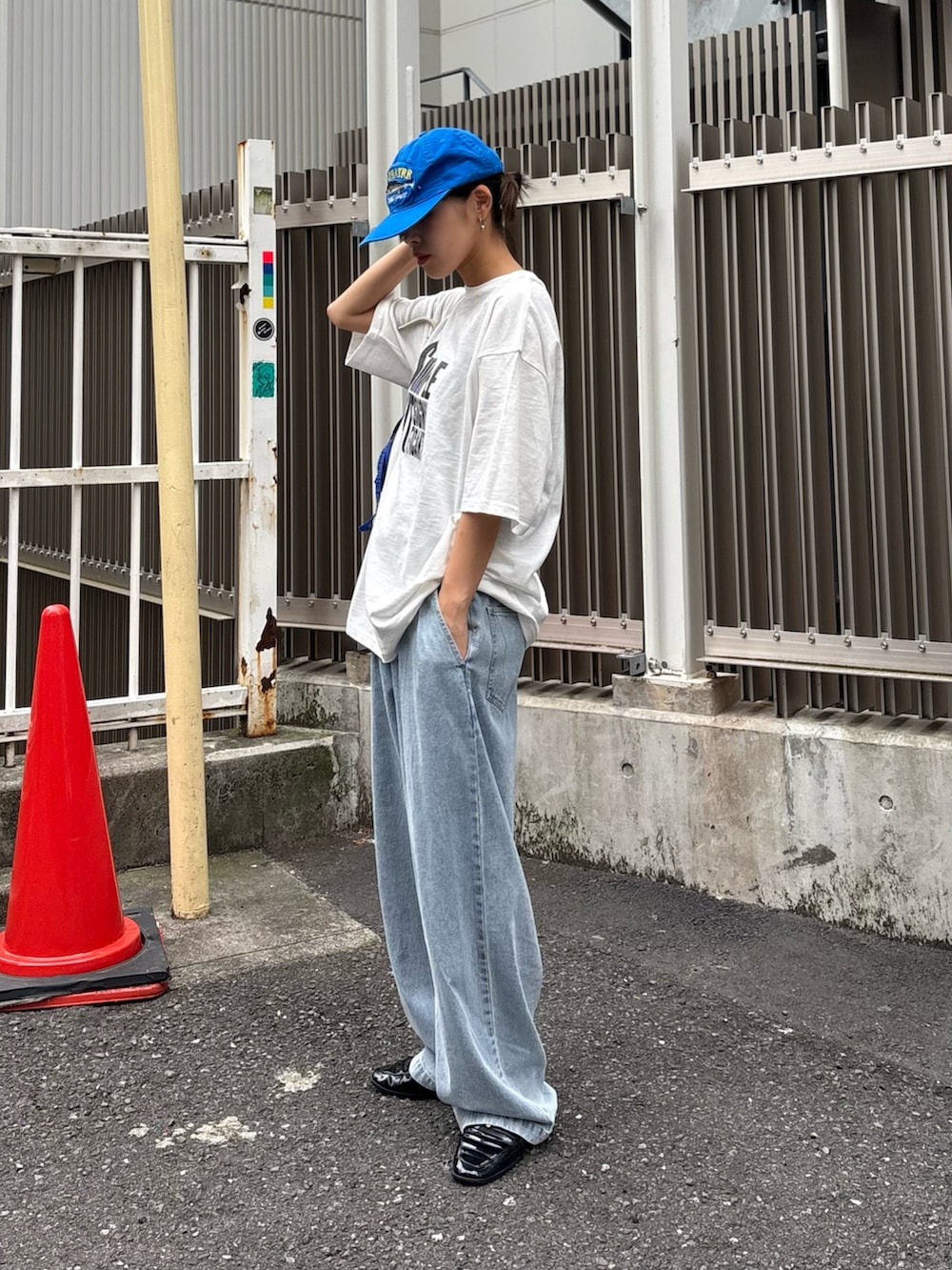 ホワイト系のTシャツ/カットソー、ブルー系のデニムパンツ、ブルー系のショルダーバッグを着用したレディースの春コーディネートの2枚目の写真