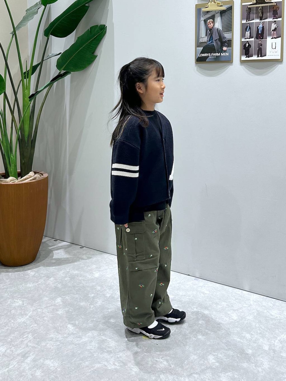 ブルー系のカーディガン/ボレロ、ブラック系のTシャツ/カットソー、グリーン系のカーゴパンツを着用したレディースの冬コーディネートの2枚目の写真