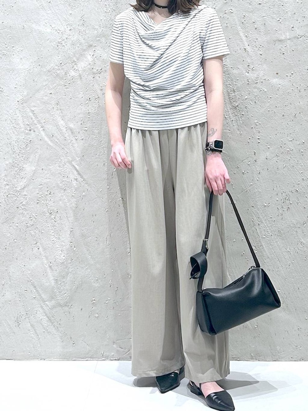 ベージュ系のその他パンツ、ホワイト系のTシャツ/カットソー、ブラック系のサンダルを着用したレディースの夏コーディネートの3枚目の写真
