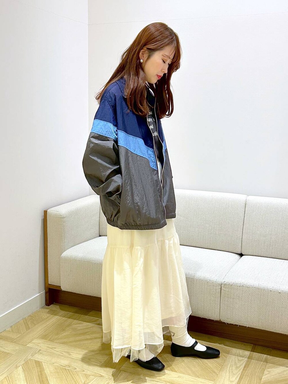 ブラック系のパンプス、ホワイト系のスカート、グレー系のTシャツ/カットソーを着用したレディースの春コーディネートの3枚目の写真