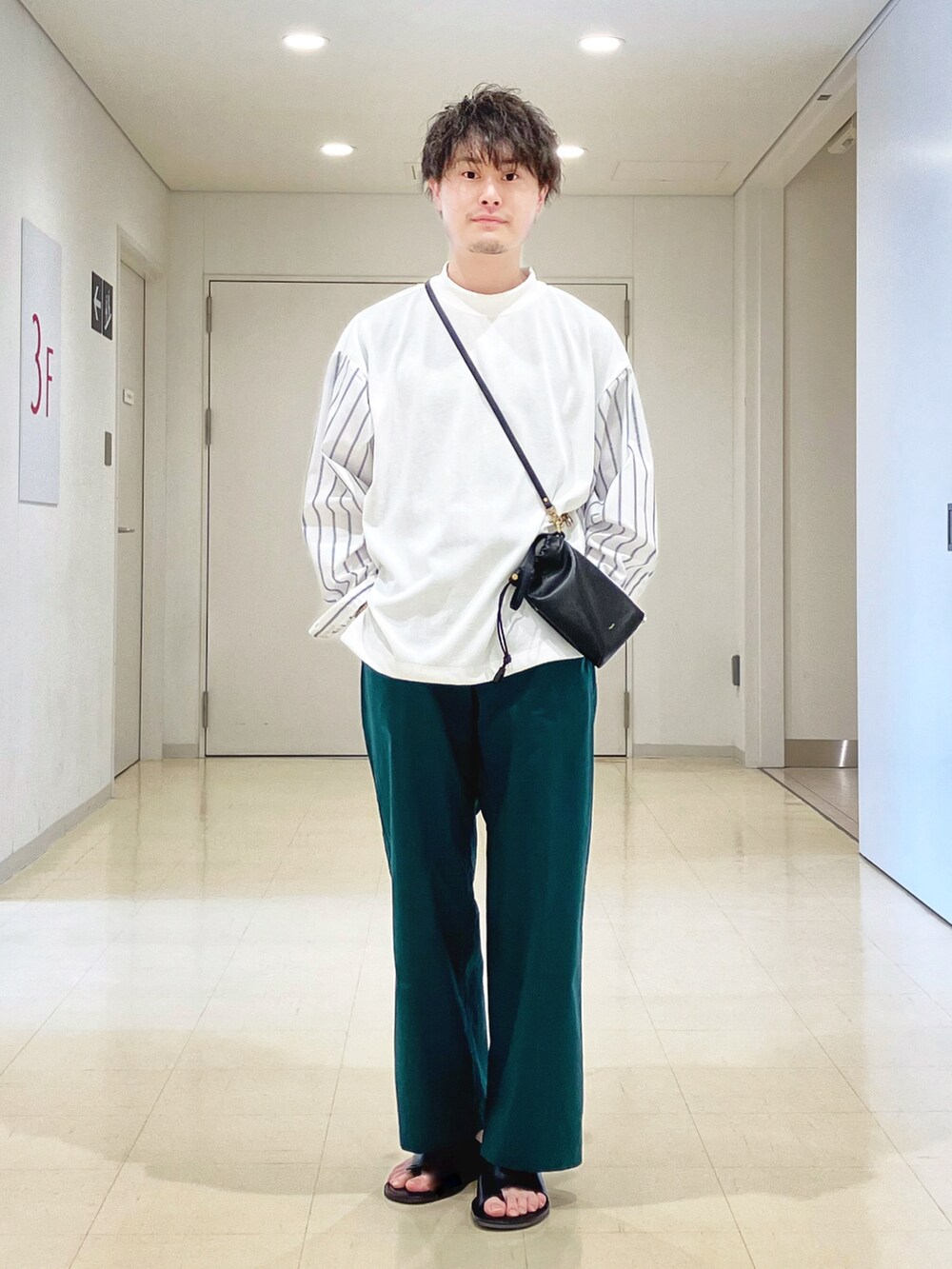 ホワイト系のTシャツ/カットソー、グリーン系のその他パンツ、ブラック系のサンダルを着用したメンズの春コーディネートの2枚目の写真