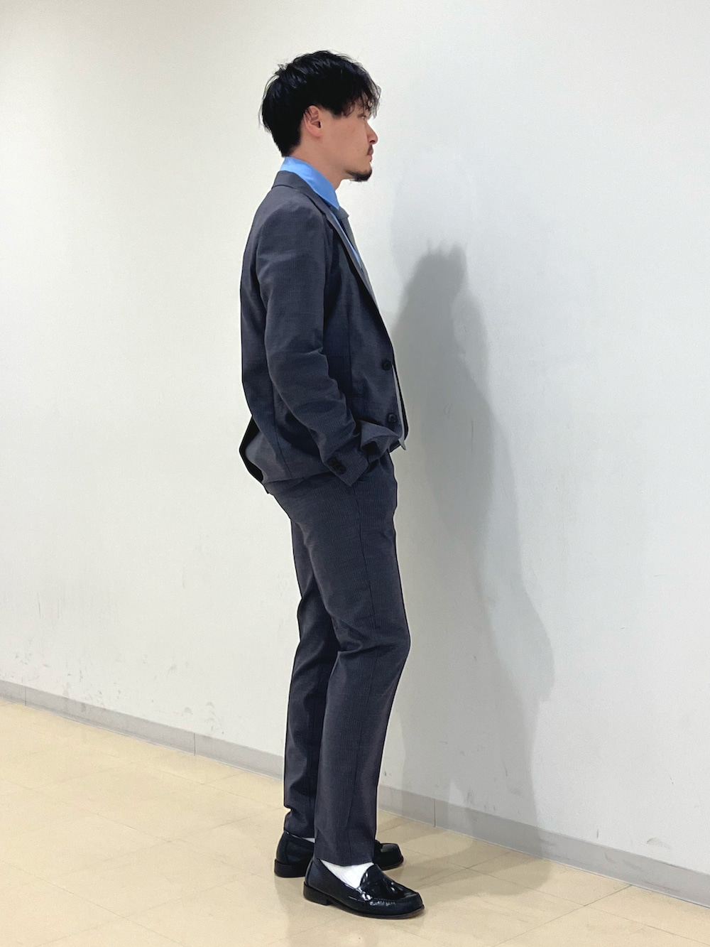 グレー系のスーツジャケット、グレー系のスラックス、ブルー系のシャツ/ブラウスを着用したメンズの春コーディネートの3枚目の写真