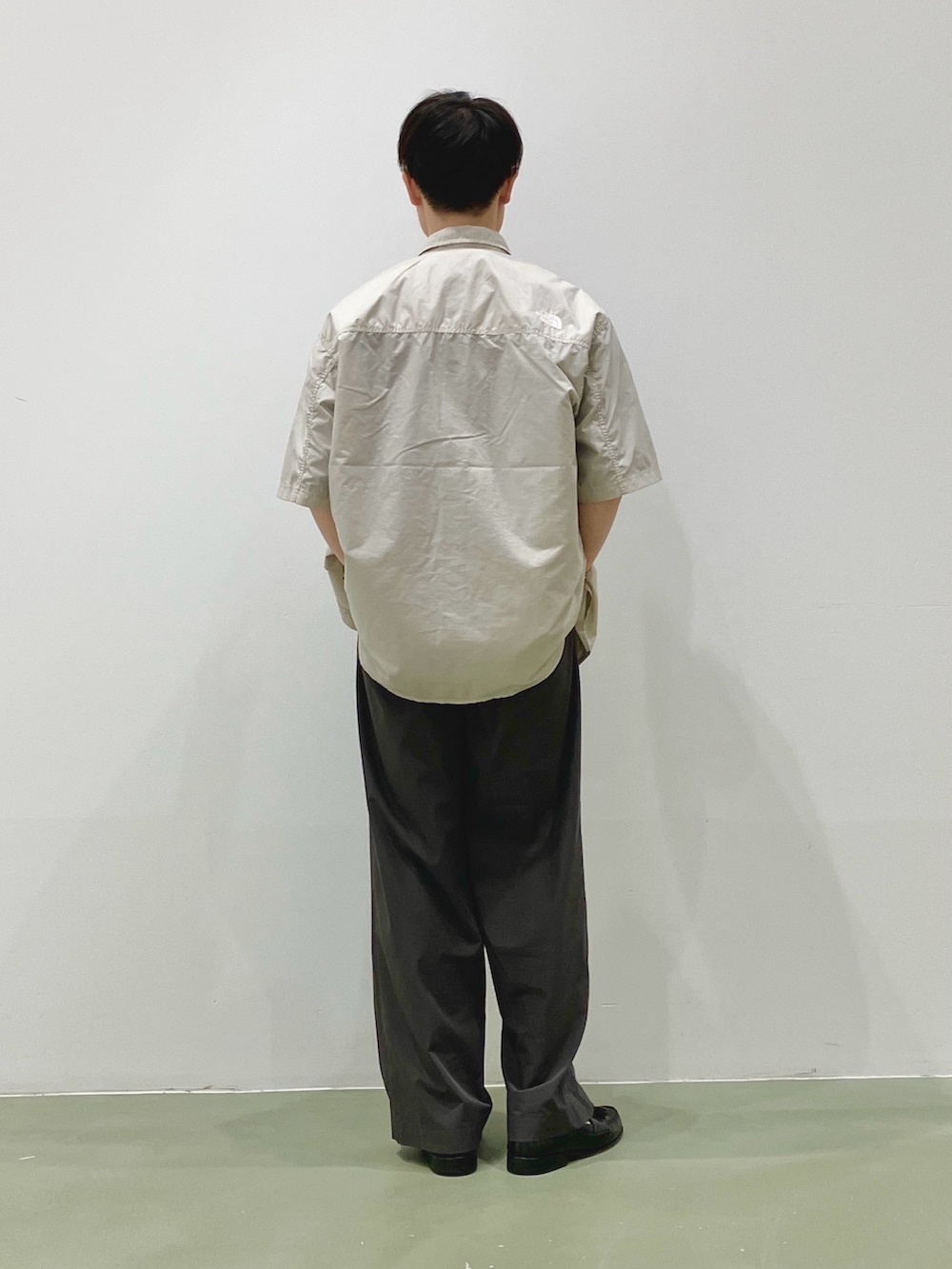 ベージュ系のシャツ/ブラウス、ブラウン系のTシャツ/カットソー、グレー系のスラックスを着用したメンズの夏コーディネートの3枚目の写真