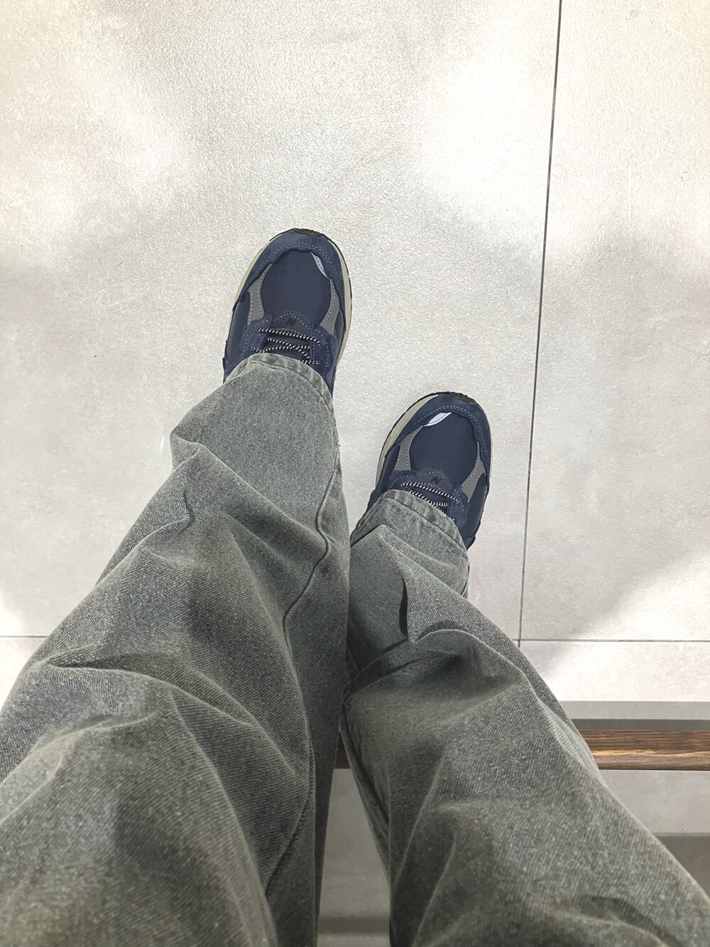 ブラック系のニット/セーター、ブラック系のデニムパンツ、ブルー系のスニーカーを着用したメンズの秋コーディネートの4枚目の写真