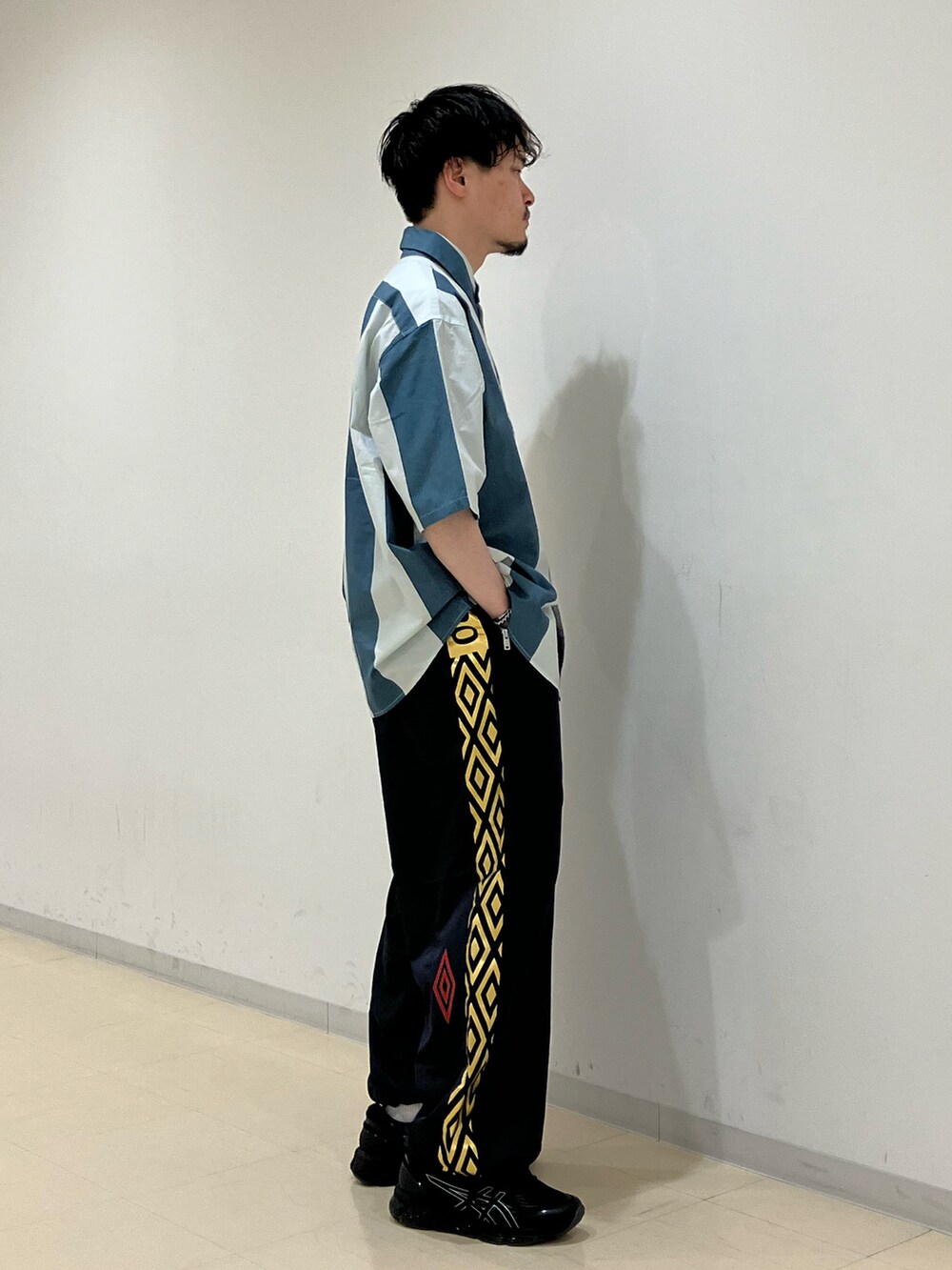 グレー系のシャツ/ブラウス、ブルー系のその他パンツ、ブラック系のスニーカーを着用したメンズの春コーディネートの2枚目の写真