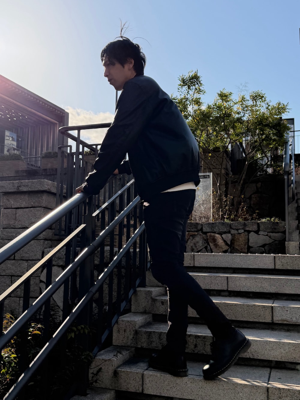 ホワイト系のTシャツ/カットソー、ブラック系のデニムパンツ、ブラック系のドレスシューズを着用したメンズの春コーディネートの3枚目の写真