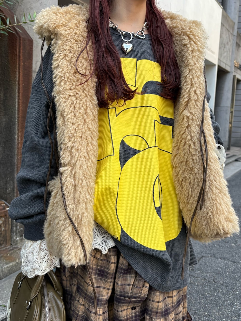 グレー系のTシャツ/カットソー、ホワイト系のTシャツ/カットソー、ベージュ系のベストを着用したレディースの秋コーディネートの4枚目の写真