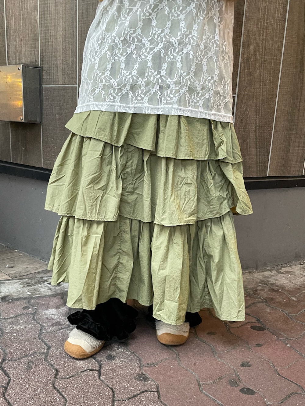 グリーン系のスカート、イエロー系のTシャツ/カットソーを着用したレディースの冬コーディネートの5枚目の写真