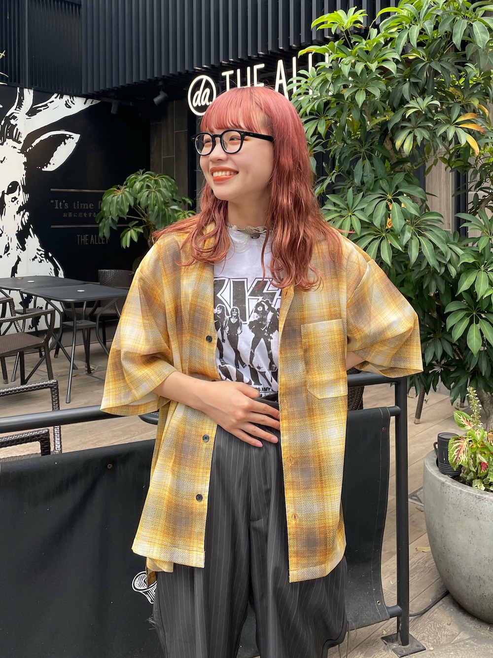 ホワイト系のTシャツ/カットソー、イエロー系のシャツ/ブラウス、グレー系のスラックスを着用したレディースの夏コーディネートの3枚目の写真