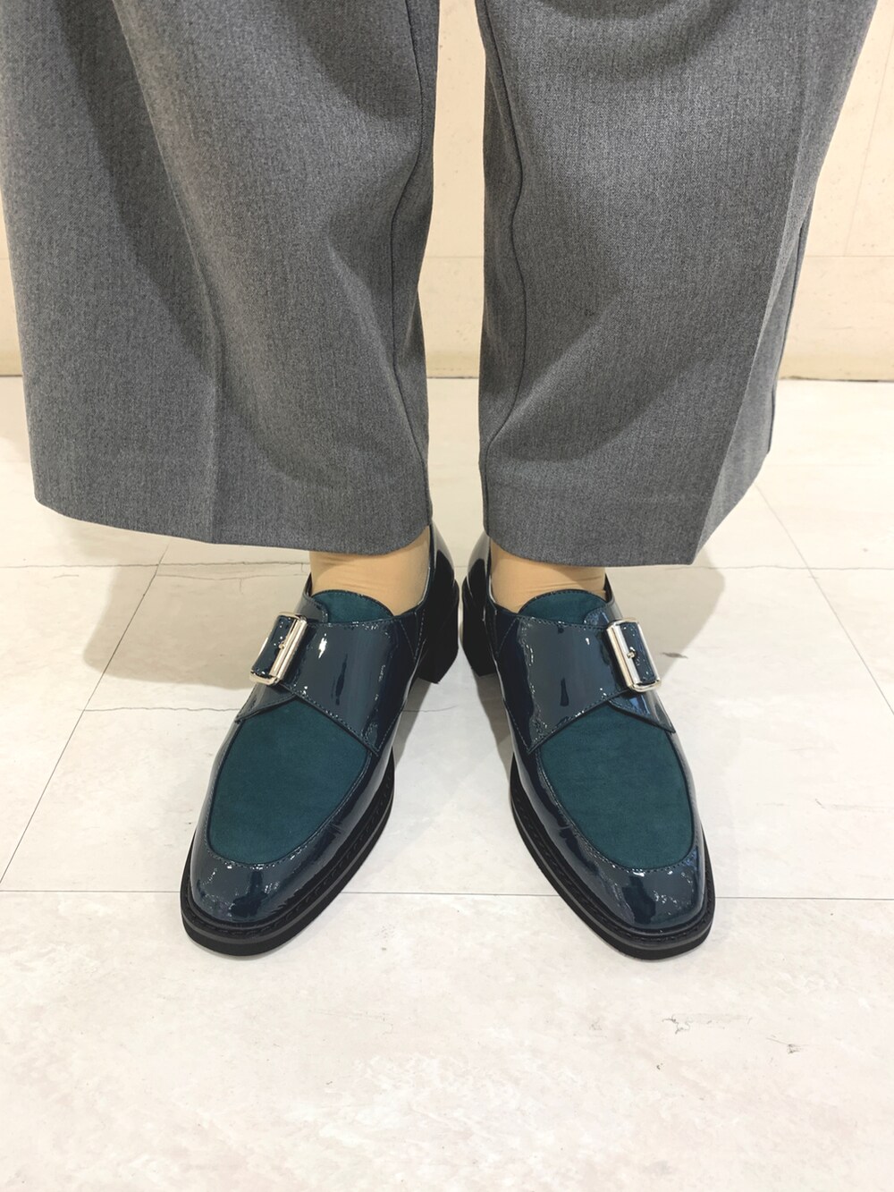 グリーン系のパンプスを着用したレディースの秋コーディネートの2枚目の写真